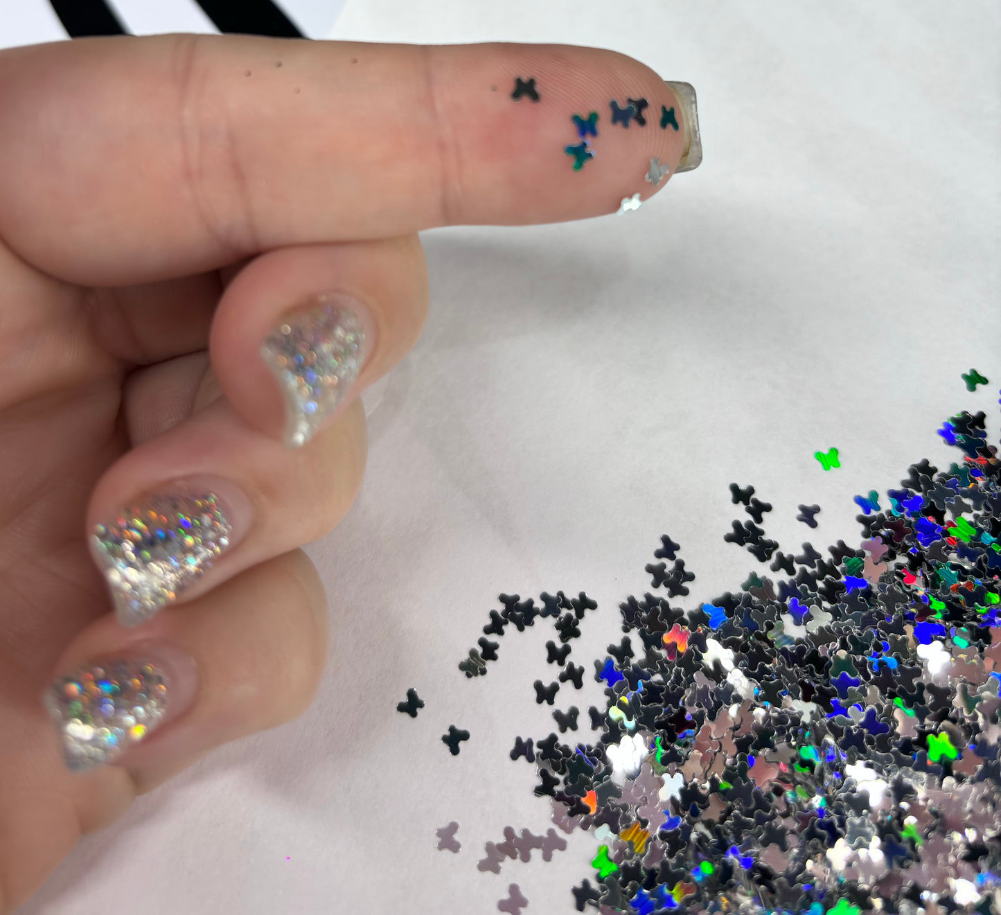 Silver holographic butterfly shaped glitter.